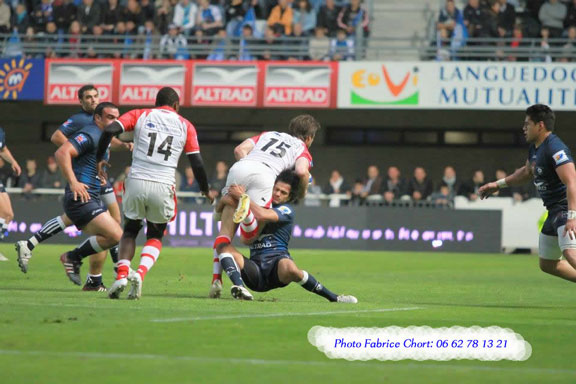 Rugby defender completing a dominant tackle after tracking the ball carrier from the inside